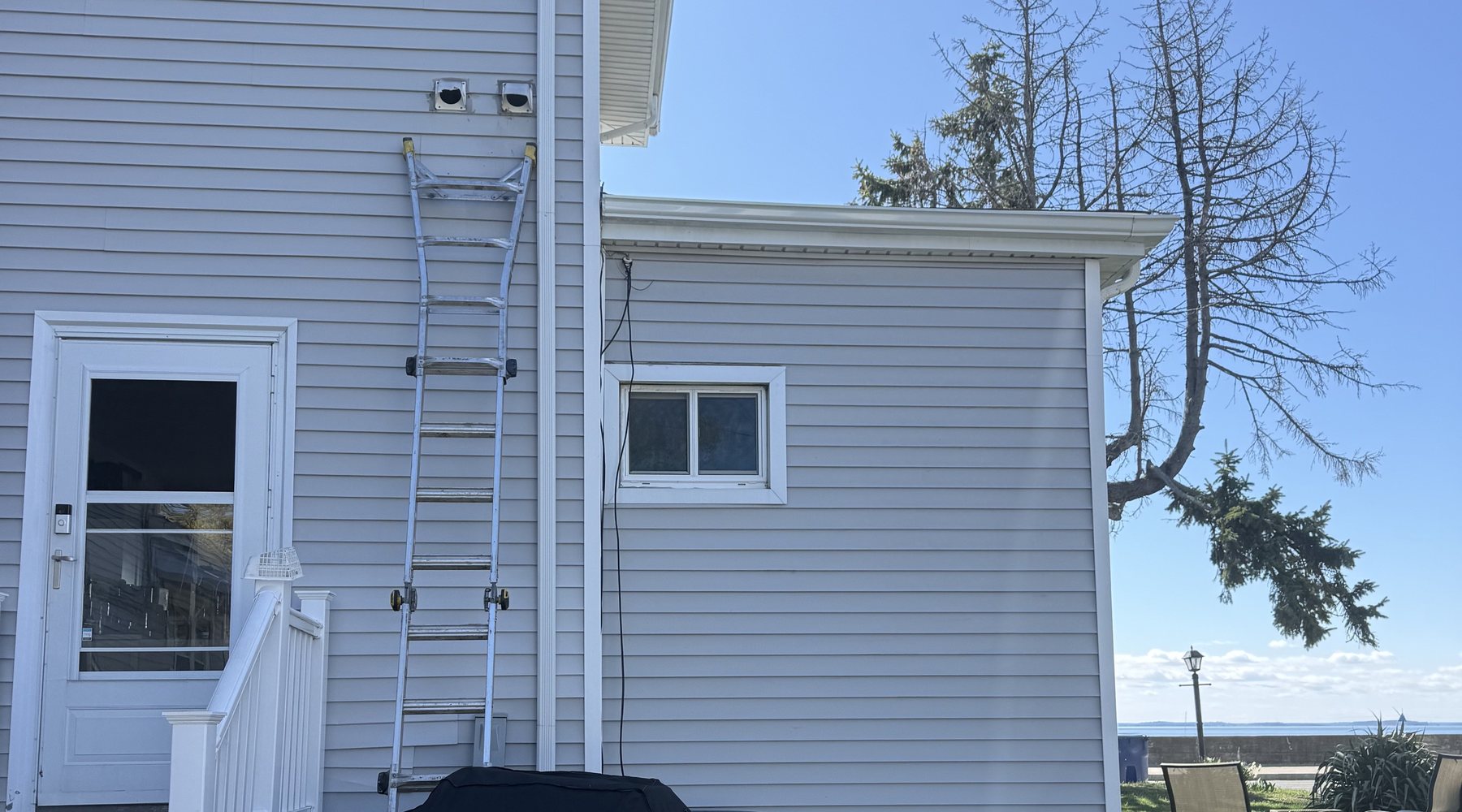 Exterior dryer vent service setup at a Greater Boston home