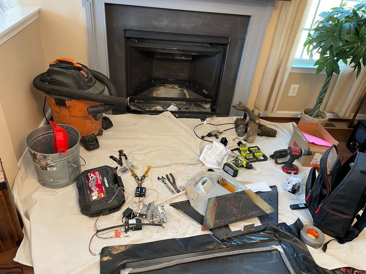 Fireplace service setup with drop cloths and tools by Mikey's Chimney in Cambridge MA