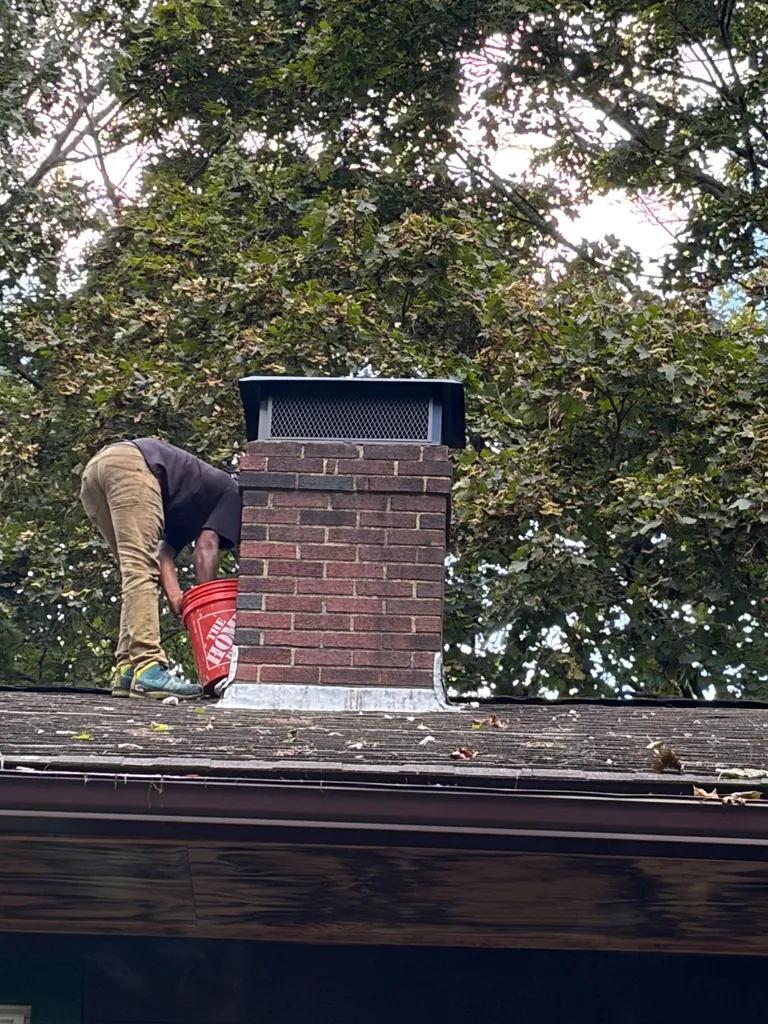 Full-coverage chimney cap installed on brick chimney in Canton MA