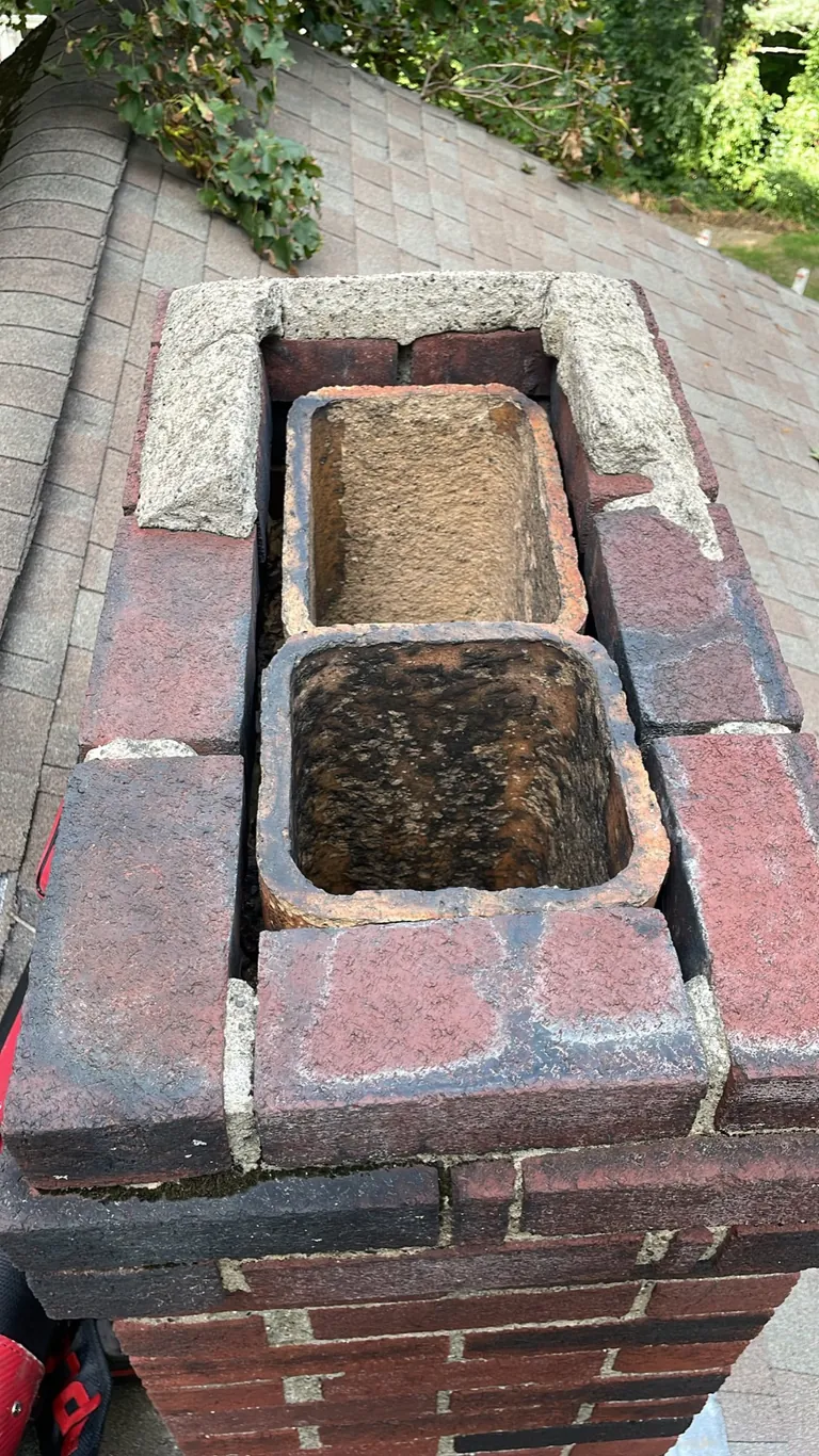 Two uncovered chimney flues and damaged crown before repair in Canton MA