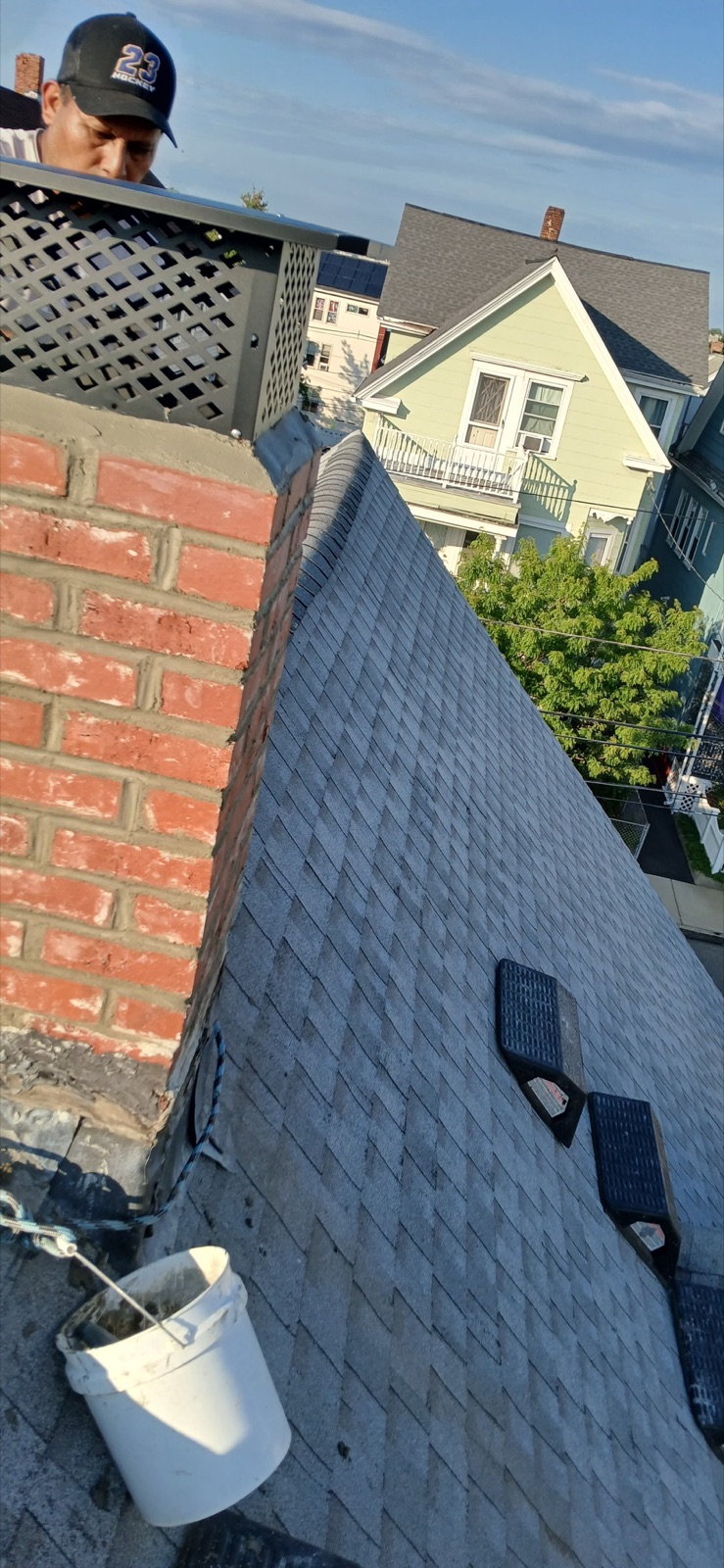 Close view of the new full-coverage chimney cap during installation