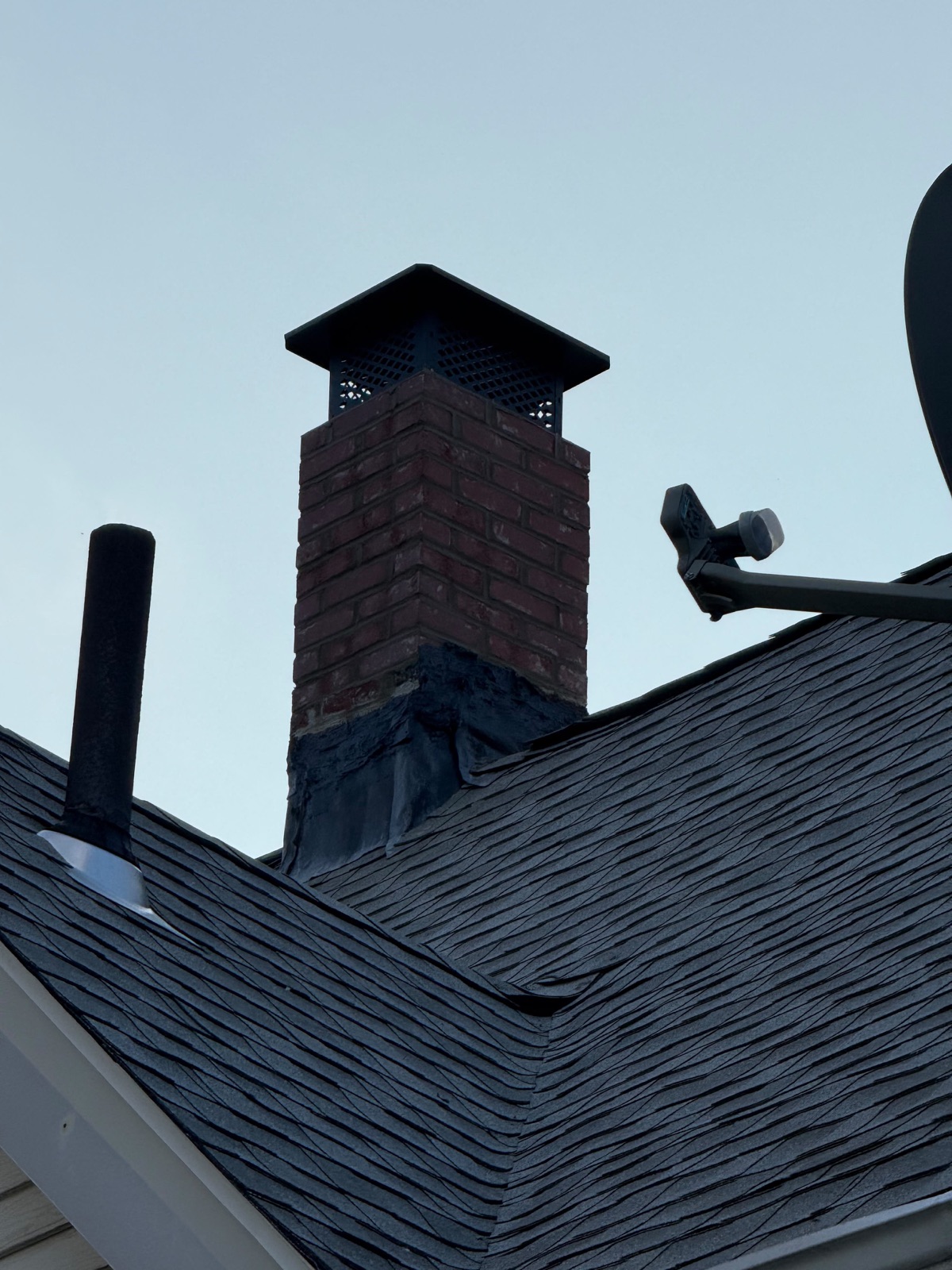 Rebuilt chimney with cap and roofline viewed from below