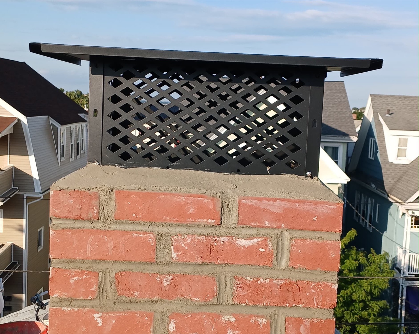 Rebuilt brick chimney and full-coverage cap in Everett MA