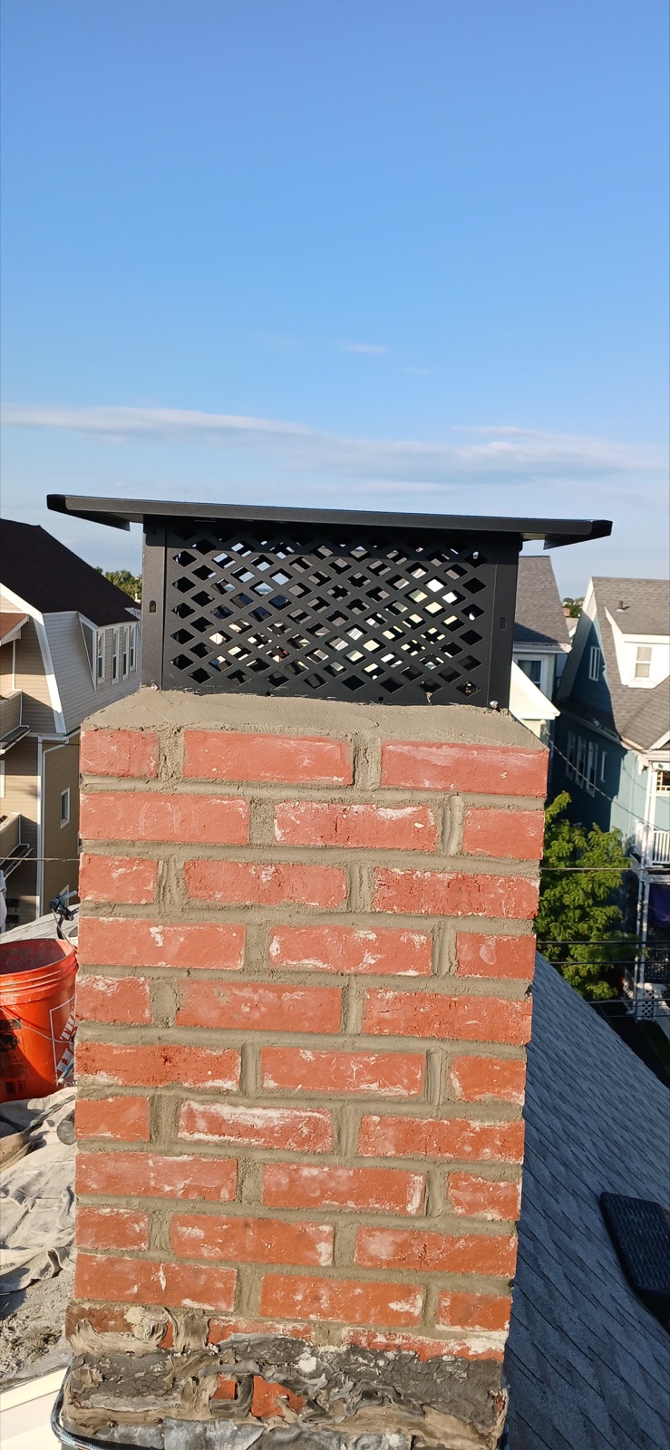 Full view of the rebuilt brick chimney and cap in Everett MA
