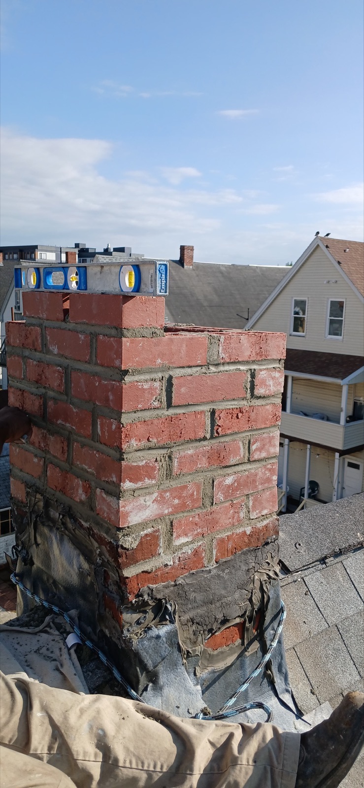New brick courses and mortar during the Everett chimney rebuild
