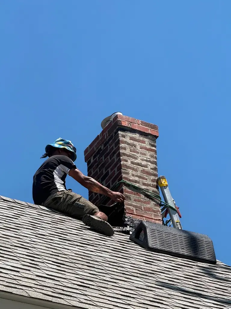 Technician performing chimney repointing in Braintree MA
