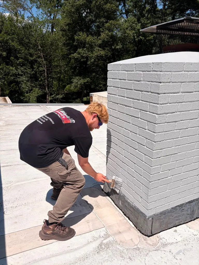 Painting the lower chimney masonry in Wayland MA