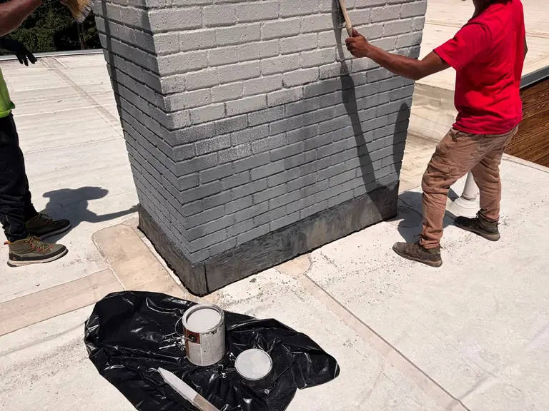Team completing exterior chimney painting in Wayland MA