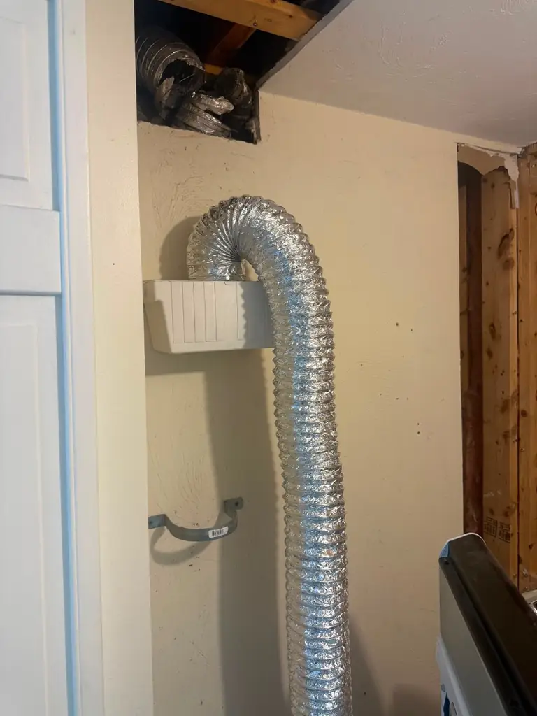 Damaged dryer vent wall area before solution in Peabody MA