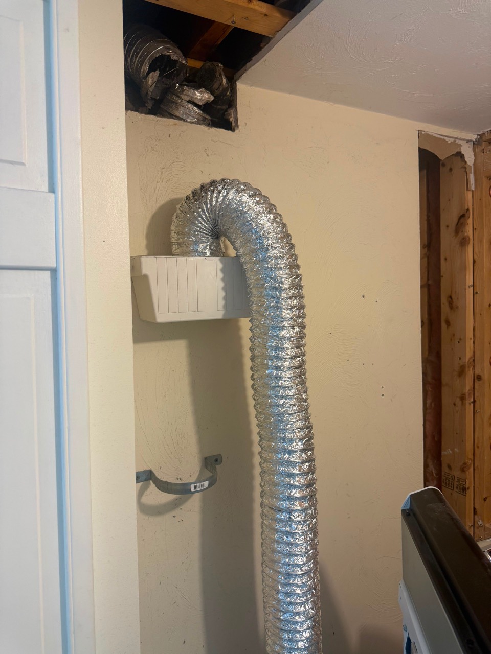 Damaged dryer vent wall area before solution in Peabody MA