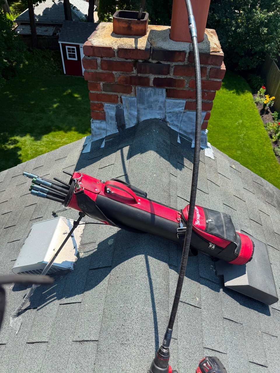Chimney cleaning brush used from roof in Marblehead MA